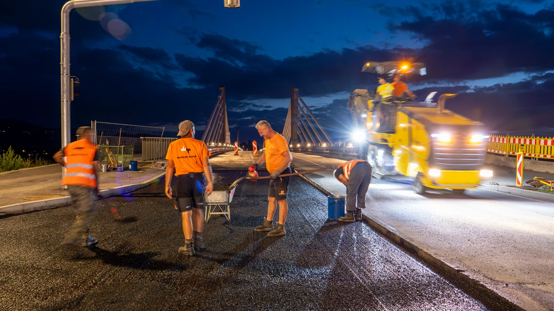 Arbeiter von Wilhelm-Mayer asphaltieren die Auffahrt zur Rheinbrücke zwischen Hard und Fußach.